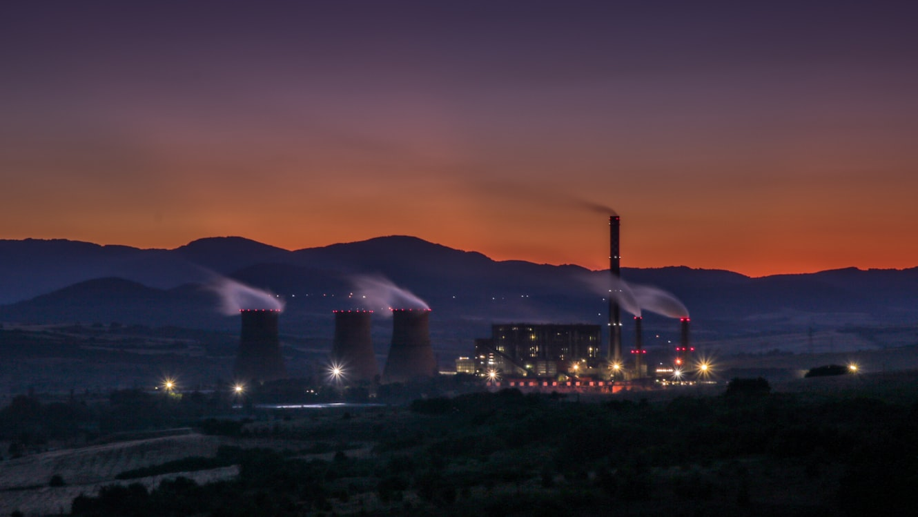 Industrial port with cranes and containers at sunset